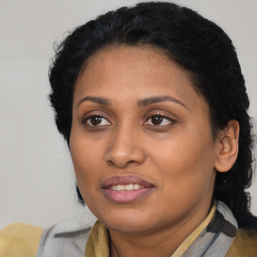 Joyful black young-adult female with medium  brown hair and brown eyes