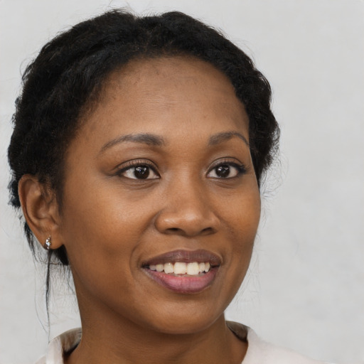 Joyful black young-adult female with medium  brown hair and brown eyes