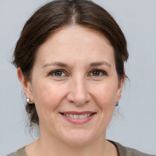 Joyful white adult female with medium  brown hair and brown eyes