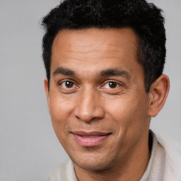 Joyful white adult male with short  black hair and brown eyes