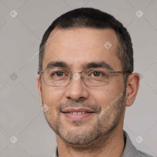 Joyful white adult male with short  black hair and brown eyes