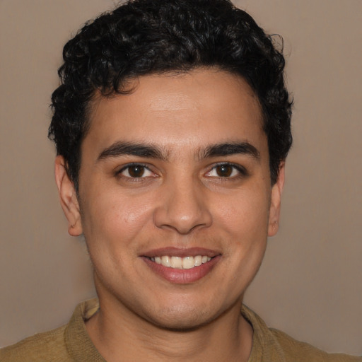 Joyful latino young-adult male with short  brown hair and brown eyes