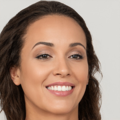 Joyful white young-adult female with long  brown hair and brown eyes