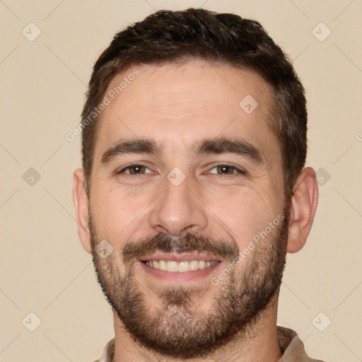 Joyful white young-adult male with short  brown hair and brown eyes