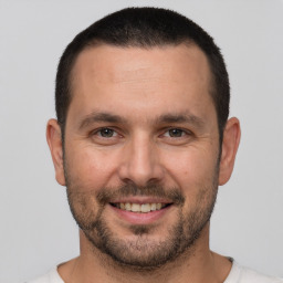 Joyful white young-adult male with short  brown hair and brown eyes