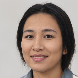 Joyful asian adult female with medium  brown hair and brown eyes