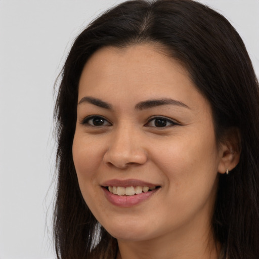 Joyful asian young-adult female with long  brown hair and brown eyes