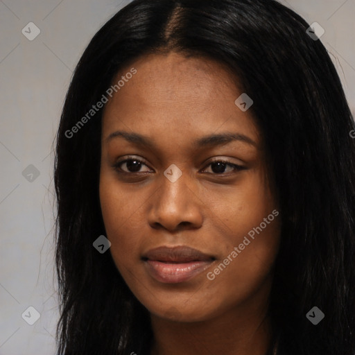 Joyful black young-adult female with long  black hair and brown eyes