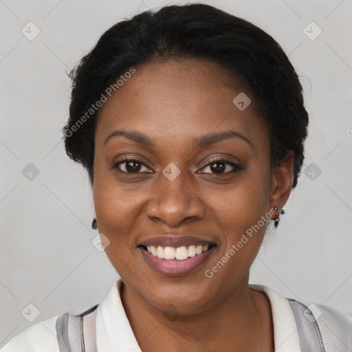 Joyful black young-adult female with short  black hair and brown eyes