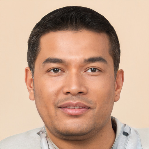 Joyful white young-adult male with short  black hair and brown eyes