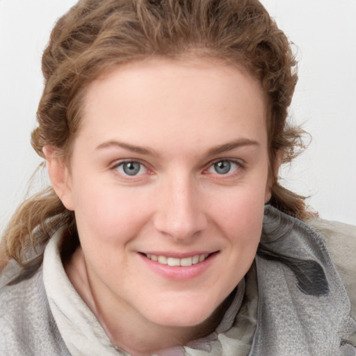 Joyful white young-adult female with medium  brown hair and blue eyes