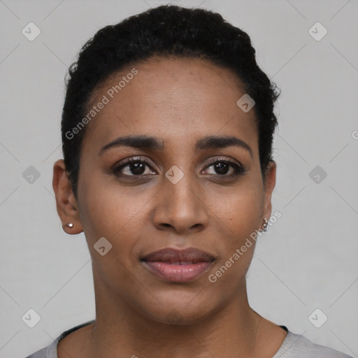 Joyful black young-adult female with short  black hair and brown eyes