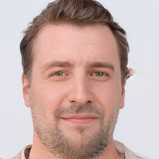 Joyful white adult male with short  brown hair and grey eyes