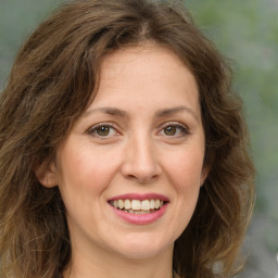 Joyful white young-adult female with long  brown hair and green eyes