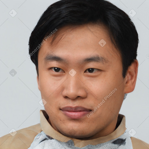 Joyful asian young-adult male with short  black hair and brown eyes