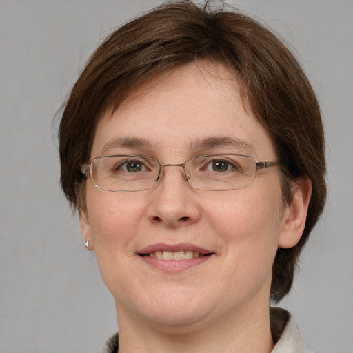 Joyful white adult female with medium  brown hair and blue eyes