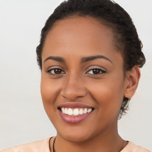 Joyful latino young-adult female with short  brown hair and brown eyes