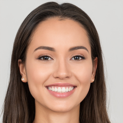 Joyful white young-adult female with long  brown hair and brown eyes