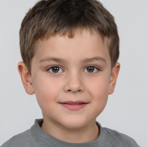 Joyful white child male with short  brown hair and brown eyes