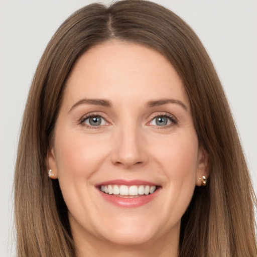 Joyful white young-adult female with long  brown hair and grey eyes