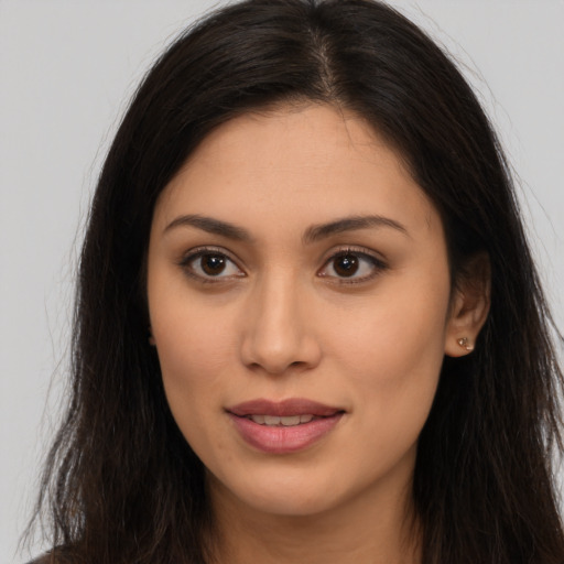 Joyful latino young-adult female with long  brown hair and brown eyes