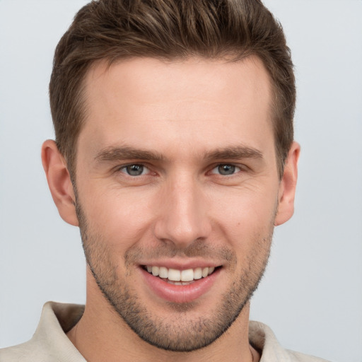 Joyful white young-adult male with short  brown hair and brown eyes