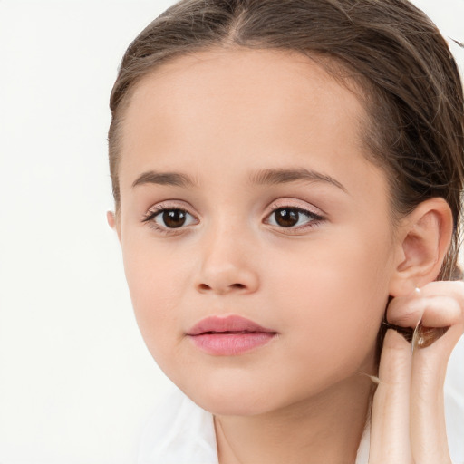 Joyful white child female with long  brown hair and brown eyes