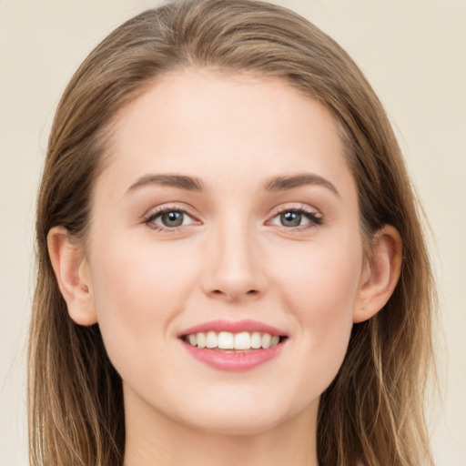 Joyful white young-adult female with long  brown hair and grey eyes