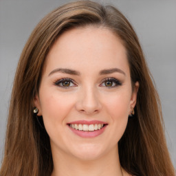 Joyful white young-adult female with long  brown hair and green eyes