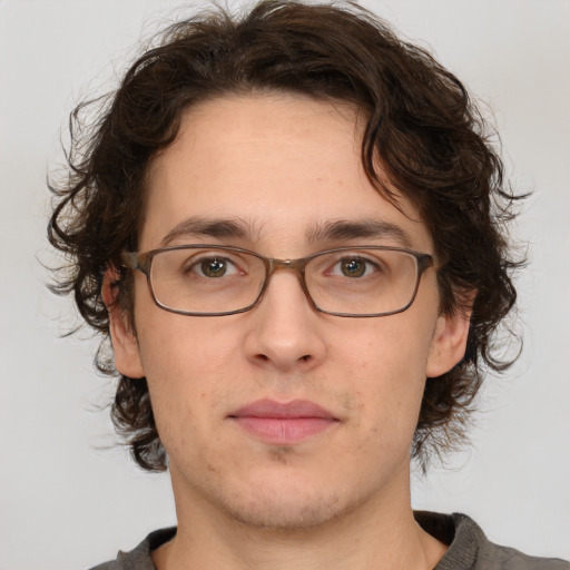 Joyful white adult male with medium  brown hair and brown eyes