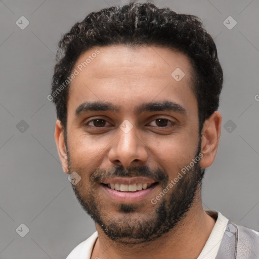 Joyful black young-adult male with short  black hair and brown eyes