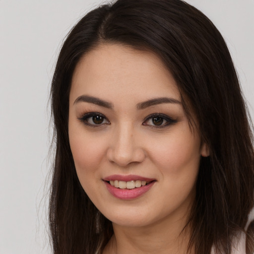 Joyful white young-adult female with long  brown hair and brown eyes