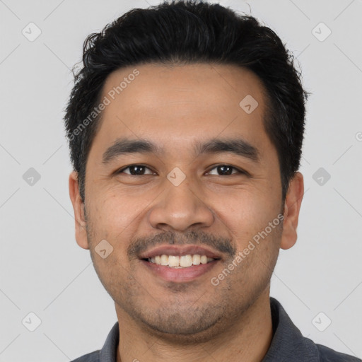 Joyful latino young-adult male with short  black hair and brown eyes