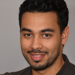 Joyful white young-adult male with short  black hair and brown eyes