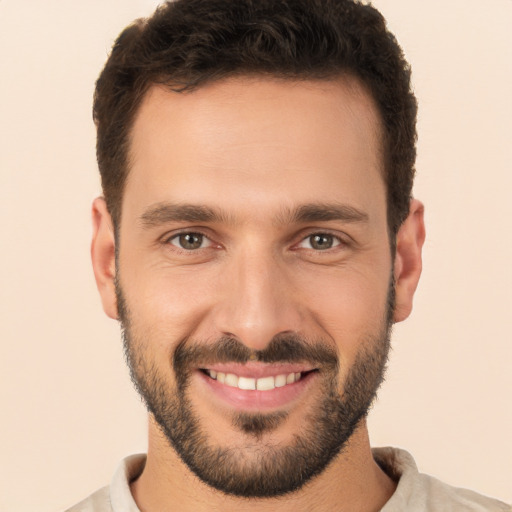 Joyful white young-adult male with short  brown hair and brown eyes