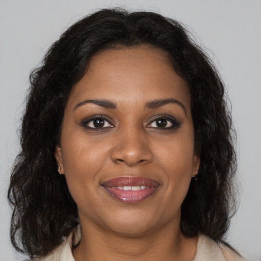 Joyful black young-adult female with medium  brown hair and brown eyes