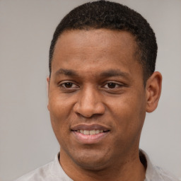 Joyful latino young-adult male with short  brown hair and brown eyes