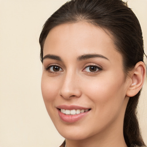 Joyful white young-adult female with long  brown hair and brown eyes