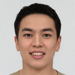 Joyful asian young-adult male with short  black hair and brown eyes