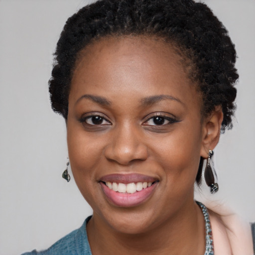 Joyful black young-adult female with short  black hair and brown eyes