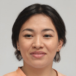 Joyful asian young-adult female with medium  brown hair and brown eyes