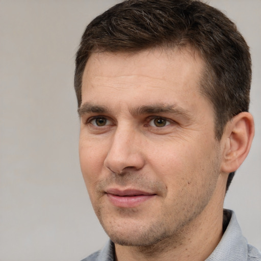 Joyful white adult male with short  brown hair and brown eyes