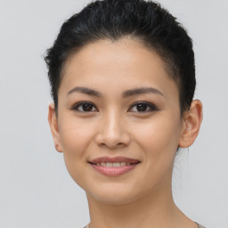 Joyful latino young-adult female with short  brown hair and brown eyes