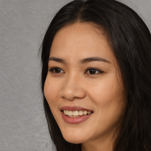 Joyful asian young-adult female with long  black hair and brown eyes