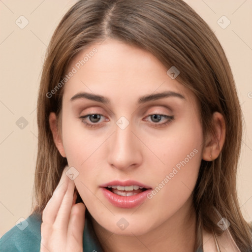 Neutral white young-adult female with long  brown hair and brown eyes