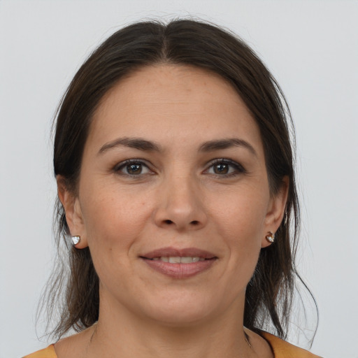 Joyful white adult female with medium  brown hair and brown eyes