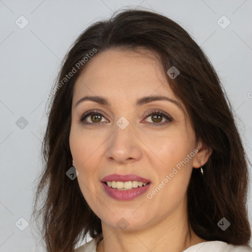 Joyful white adult female with long  brown hair and brown eyes