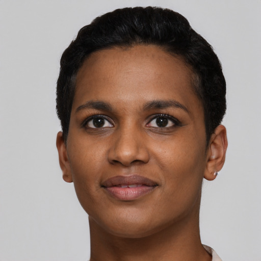 Joyful black young-adult female with short  black hair and brown eyes
