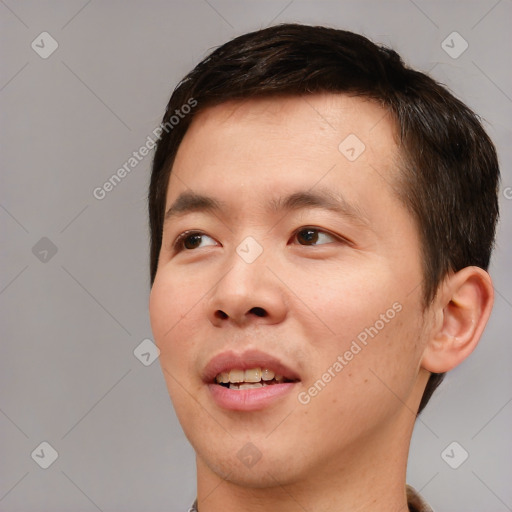 Joyful asian young-adult male with short  brown hair and brown eyes