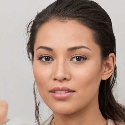 Joyful white young-adult female with long  brown hair and brown eyes